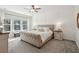 Light and bright main bedroom boasts a neutral color palette, large windows, and detailed wainscoting at 3082 Emma Ln, Mount Pleasant, SC 29466