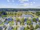 Scenic aerial view of a planned community with a lake, green spaces, and colorful homes against a treed horizon at 312 Germander Ave, Summerville, SC 29483