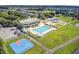 A beautiful aerial view showcasing community pool, playground, basketball court, parking, and lush surroundings at 312 Germander Ave, Summerville, SC 29483
