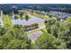 Overhead of tennis courts, with a scenic pond and neighborhood homes nestled among mature trees in background at 312 Germander Ave, Summerville, SC 29483