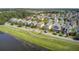 Scenic aerial view of a vibrant neighborhood with colorful homes, lush greenery, and a serene lake at 312 Germander Ave, Summerville, SC 29483