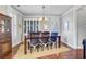 Bright dining room boasts hardwood floors, chandelier, and a large china cabinet at 312 Germander Ave, Summerville, SC 29483