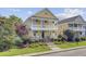 Two-story home featuring double porches, beautiful landscaping, concrete stairs, and a manicured lawn at 312 Germander Ave, Summerville, SC 29483
