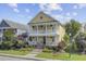 Charming yellow two-story home with double porches, white railings and columns, and manicured landscaping at 312 Germander Ave, Summerville, SC 29483