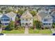 Charming yellow home with double front porches in a colorful neighborhood with mature trees and manicured lawns at 312 Germander Ave, Summerville, SC 29483