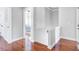 Hallway with wood floors and neutral walls leading to rooms with tray ceilings at 312 Germander Ave, Summerville, SC 29483