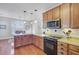 Traditional eat-in kitchen features wood cabinets, granite countertops, and modern stainless steel appliances at 312 Germander Ave, Summerville, SC 29483