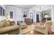 Spacious living room with hardwood floors, comfortable seating, and an open doorway to the dining area at 312 Germander Ave, Summerville, SC 29483