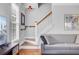 Cozy living room with a gray sofa, staircase, and a window letting in natural light at 312 Germander Ave, Summerville, SC 29483
