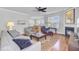 Open-concept living room with fireplace, hardwood floors, and natural light at 312 Germander Ave, Summerville, SC 29483
