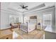 Spacious main bedroom features tray ceiling, ceiling fan, and two windows overlooking the yard at 312 Germander Ave, Summerville, SC 29483