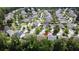 Aerial view of a single Gathering home in a wooded neighborhood with sidewalks and street parking at 3198 Conservancy Ln, Charleston, SC 29414