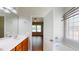 Bright bathroom features a double sink vanity, soaking tub, and an open-doorway to the bedroom at 3198 Conservancy Ln, Charleston, SC 29414