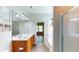 Bright bathroom features a double sink vanity, large mirror, and shower with glass door at 3198 Conservancy Ln, Charleston, SC 29414