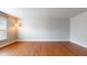 Bedroom with hardwood floors, neutral walls, and a lamp next to a large window at 3198 Conservancy Ln, Charleston, SC 29414