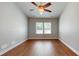 A bedroom featuring a ceiling fan, hardwood floors, and two windows to let in natural light at 3198 Conservancy Ln, Charleston, SC 29414
