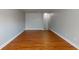 An empty bedroom featuring hardwood floors, baseboards, and neutral walls ready for customization at 3198 Conservancy Ln, Charleston, SC 29414