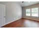 A bedroom featuring hardwood floors and a window to let in natural light at 3198 Conservancy Ln, Charleston, SC 29414