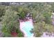 Overhead shot of a beautiful community pool with lounge chairs, umbrellas, and nearby playground at 3198 Conservancy Ln, Charleston, SC 29414