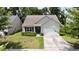 Charming one story home featuring a two-car garage, manicured lawn and mature trees at 3198 Conservancy Ln, Charleston, SC 29414