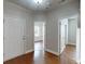 Bright foyer featuring hardwood flooring, neutral paint and multiple doors leading to other rooms in the house at 3198 Conservancy Ln, Charleston, SC 29414
