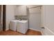 Bright laundry room with white washer and dryer, overhead storage and hanging rack at 3198 Conservancy Ln, Charleston, SC 29414