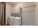 The laundry room has a washer, dryer, white cabinets, and tile flooring for efficient cleaning at 3198 Conservancy Ln, Charleston, SC 29414