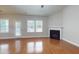 Sunlit living room featuring a fireplace and back door that leads to a fenced-in backyard at 3198 Conservancy Ln, Charleston, SC 29414