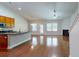 A spacious living room combines the kitchen, dining, and living area with wood floors and ample light at 3198 Conservancy Ln, Charleston, SC 29414