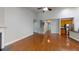 Open-concept living space with hardwood floors, fireplace, and view to the staircase and kitchen at 3198 Conservancy Ln, Charleston, SC 29414