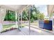 View of a screened porch, perfect for enjoying the outdoors, featuring lighting and a view of the green backyard at 3198 Conservancy Ln, Charleston, SC 29414