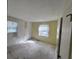 Bedroom with wallpapered and painted walls, two windows with curtain and bare concrete floors at 321 Fairington Dr, Summerville, SC 29485