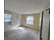 Bedroom with wallpapered and painted walls, two windows with curtain and bare concrete floors at 321 Fairington Dr, Summerville, SC 29485
