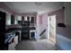 Kitchen with tile floors, dated appliances, and stairs to the right at 321 Fairington Dr, Summerville, SC 29485