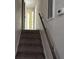 Carpeted staircase with wooden handrail and wall-mounted thermostat at 321 Fairington Dr, Summerville, SC 29485