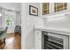 Elegant bar area with wine fridge, custom cabinetry, and marble countertops at 3224 Hatchway Dr, Mount Pleasant, SC 29466
