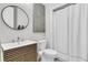 Modern bathroom with a stylish vanity, round mirror, and shower with white curtain at 3224 Hatchway Dr, Mount Pleasant, SC 29466