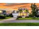 Beautiful two-story home with a front porch, palm trees, and well-manicured lawn, showcasing its curb appeal at 3224 Hatchway Dr, Mount Pleasant, SC 29466