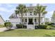 Inviting two-story home featuring a spacious front porch, elegant columns, and lush landscaping at 3224 Hatchway Dr, Mount Pleasant, SC 29466