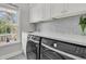 Modern laundry room equipped with front loading washer and dryer and quartz countertop at 3224 Hatchway Dr, Mount Pleasant, SC 29466