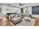 Bright living room with hardwood floors, a comfortable seating area, and a view of the modern kitchen at 3224 Hatchway Dr, Mount Pleasant, SC 29466