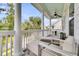 Relaxing covered porch with comfortable outdoor lounge furniture, ceiling fans, and lush greenery views at 3224 Hatchway Dr, Mount Pleasant, SC 29466