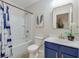 Bathroom with a blue vanity, shower with tub, and coordinated decor at 339 Iveson Rd, Summerville, SC 29486