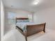 Bedroom showcasing a wooden bed frame, plush carpet, and ample natural light from two windows at 339 Iveson Rd, Summerville, SC 29486