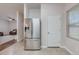 Open kitchen with stainless steel refrigerator, adjacent to hardwood floored living area at 339 Iveson Rd, Summerville, SC 29486