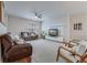 Spacious living room features plush seating, ceiling fan, large windows, entertainment center and neutral tones at 339 Iveson Rd, Summerville, SC 29486