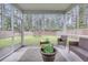 Relaxing screened porch with wicker furniture, lush greenery, and scenic backyard views at 339 Iveson Rd, Summerville, SC 29486
