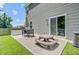 Spacious backyard patio with outdoor seating, table umbrella and green grass, perfect for entertaining at 352 Matuskovic Dr, Charleston, SC 29414