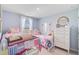 A charming bedroom that shows off two twin beds, natural light, and a chest of drawers at 352 Matuskovic Dr, Charleston, SC 29414