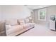 Bright bedroom with a cozy couch and view to the outdoors. Well-lit with a window, offering a serene retreat at 352 Matuskovic Dr, Charleston, SC 29414